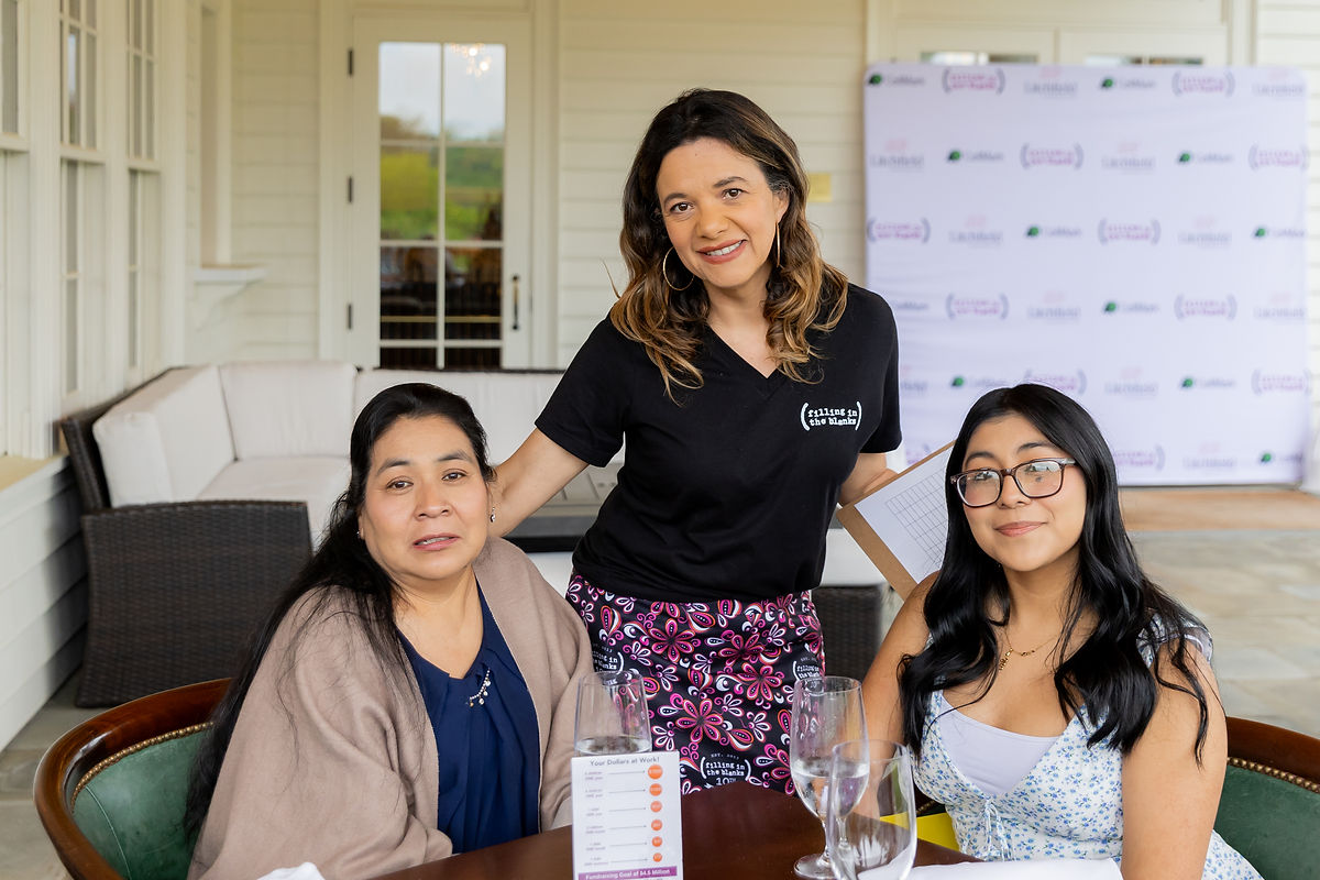 Yesenia and her mom with Filling in the Blanks’s Paola Arango, Family & Community Engagement Coordinator.