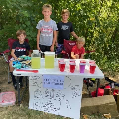 Kids running a lemonade stand as a fundraiser for Filling in the Blanks